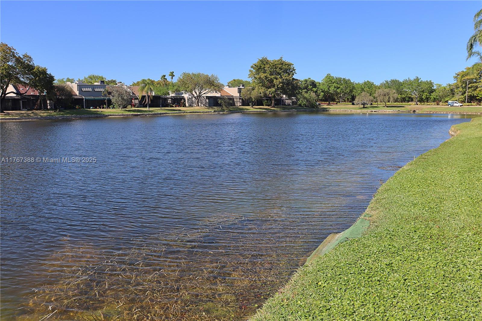 1206 North Hiatus Road, Unit 1206 Pembroke Pines, FL 33026 - Photo 4 of 18 a view of a lake with houses in the back