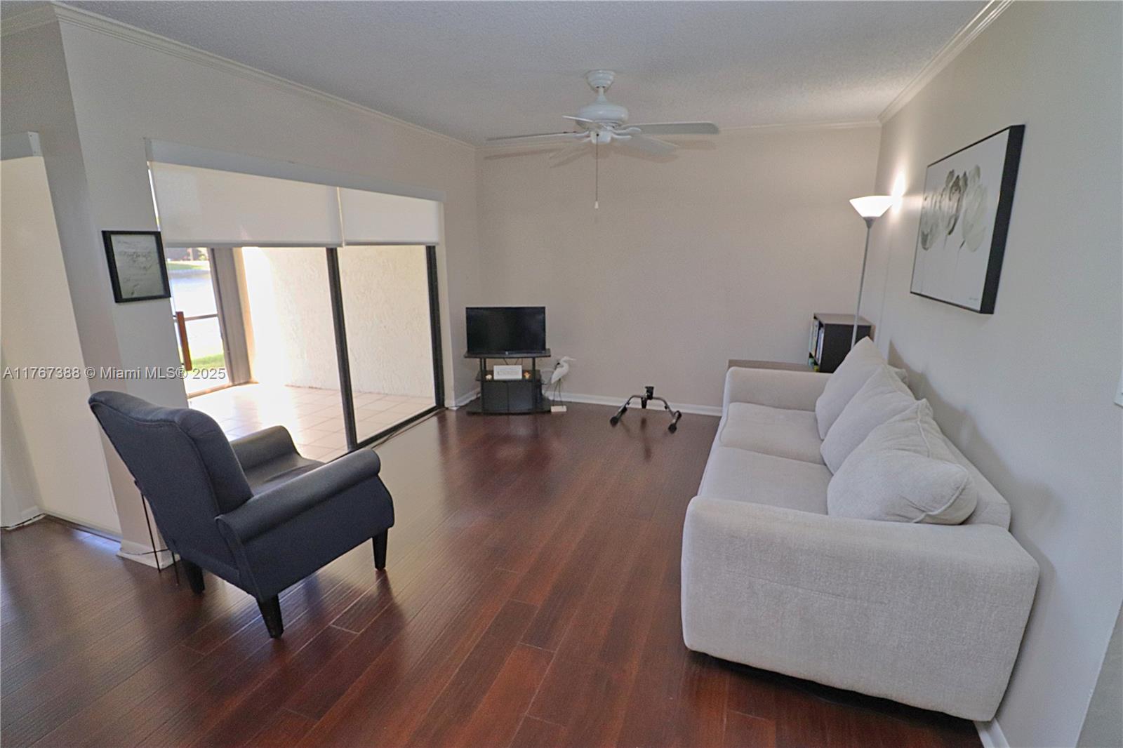1206 North Hiatus Road, Unit 1206 Pembroke Pines, FL 33026 - Photo 5 of 18 a living room with furniture and a large window