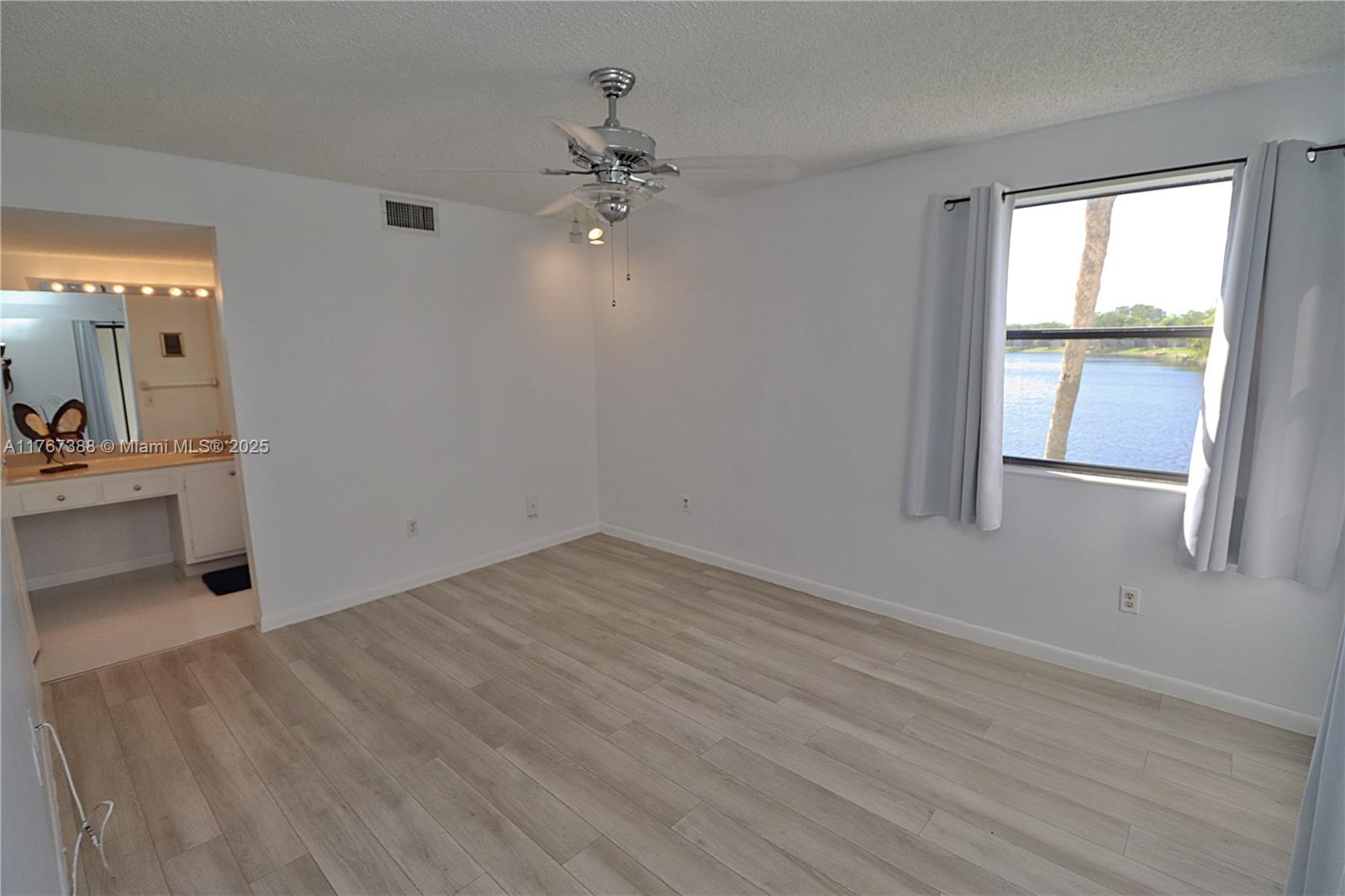1206 North Hiatus Road, Unit 1206 Pembroke Pines, FL 33026 - Photo 10 of 18 wooden floor in an empty room with a window