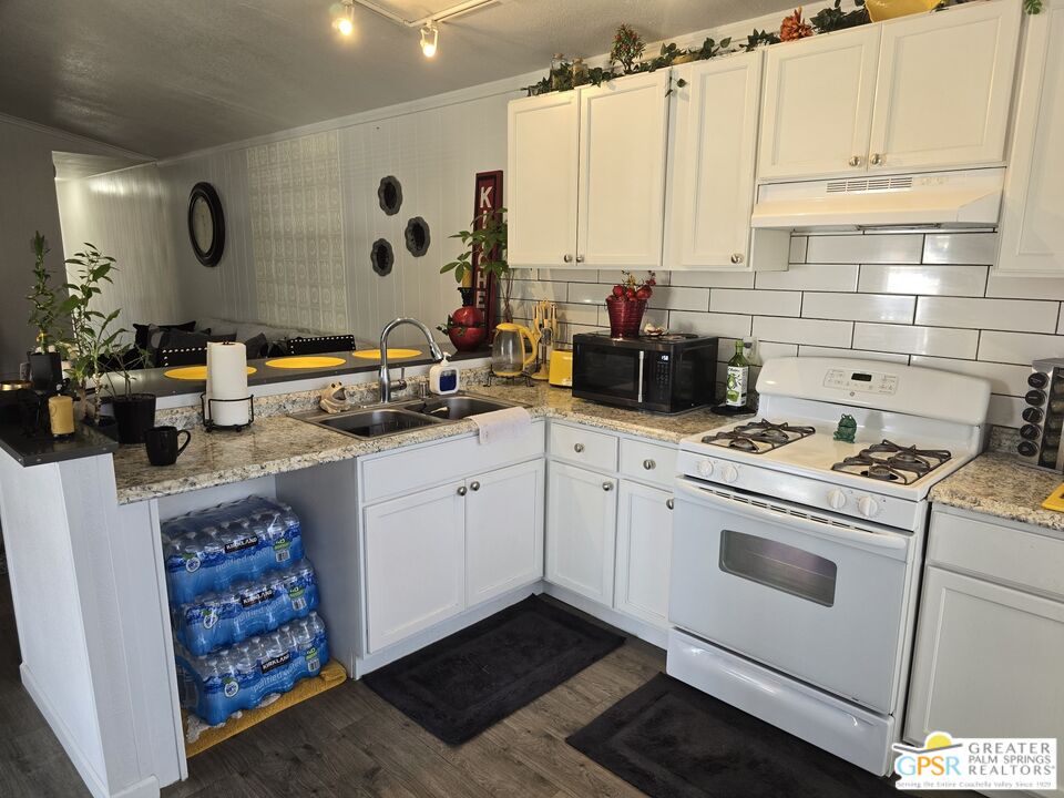 1 Running H Palm Desert, CA 92260 - Photo 6 of 22 a kitchen with stainless steel appliances a stove a sink and a refrigerator