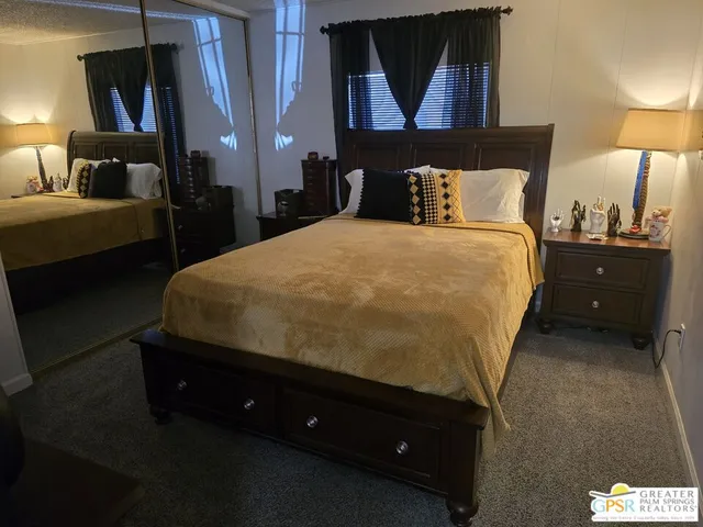 a bedroom with a bed and a lamp
