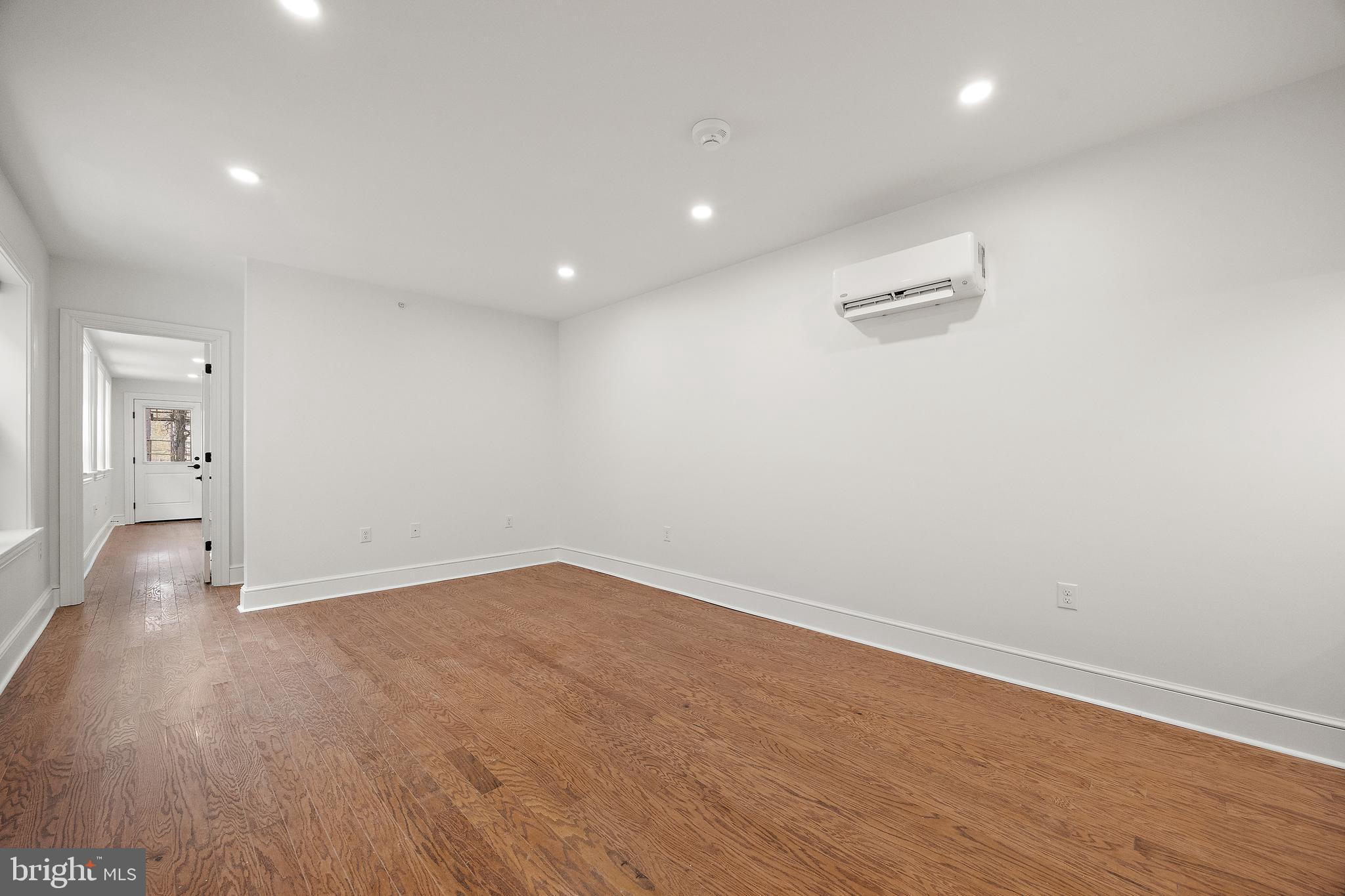 839-841 North Tatnall Street, Unit 201 Wilmington, DE 19801 - Photo 2 of 11 an empty room with wooden floor and windows