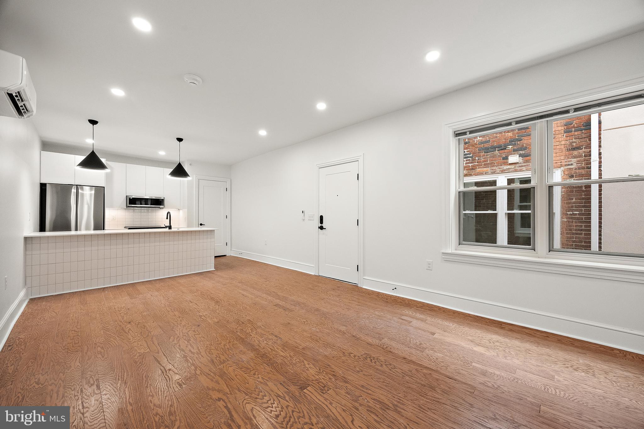 839-841 North Tatnall Street, Unit 201 Wilmington, DE 19801 - Photo 3 of 11 a view of an empty room with kitchen and window