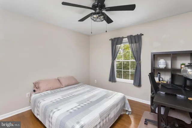 a bedroom with a bed and a desk