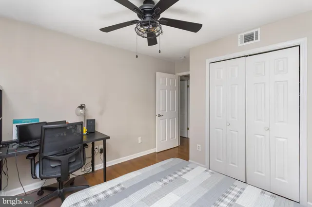 a bedroom with a bed and a desk