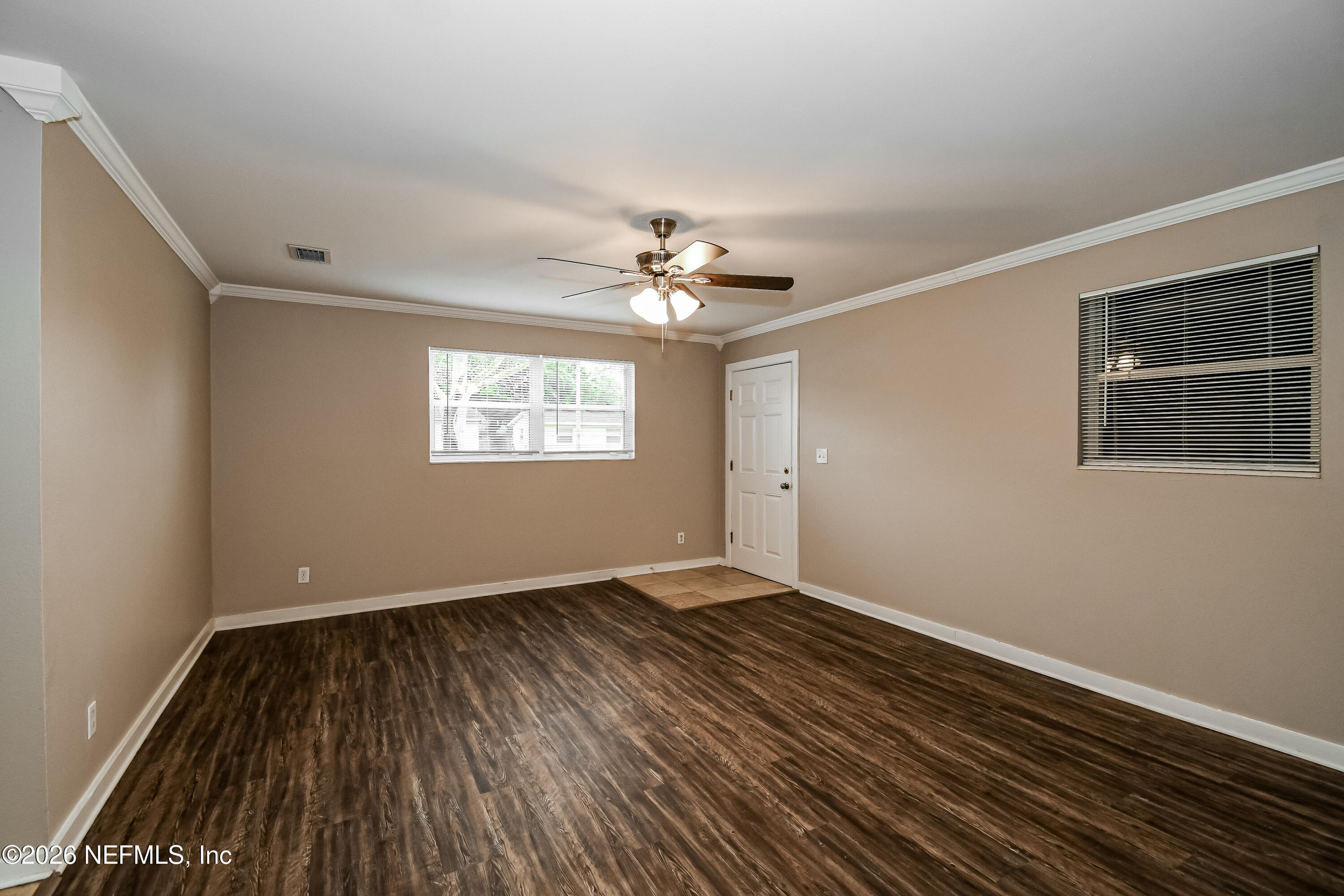 7227 Stonehurst Road North Jacksonville, FL 32277 - Photo 2 of 16 a view of an empty room with wooden floor and a window