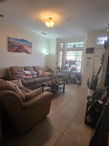 a living room with furniture a lamp and a flat screen tv
