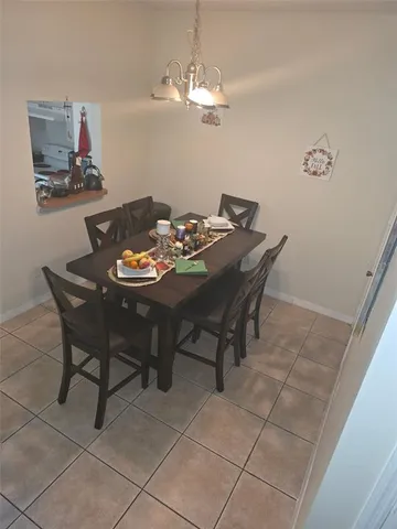 a dining room with furniture and chandelier