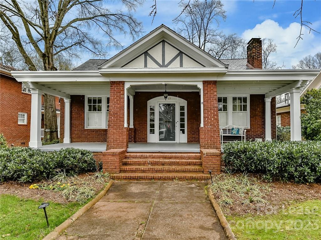 1923 Ewing Avenue Charlotte, NC 28203 - Photo 1 of 39 a front view of a house with a garden