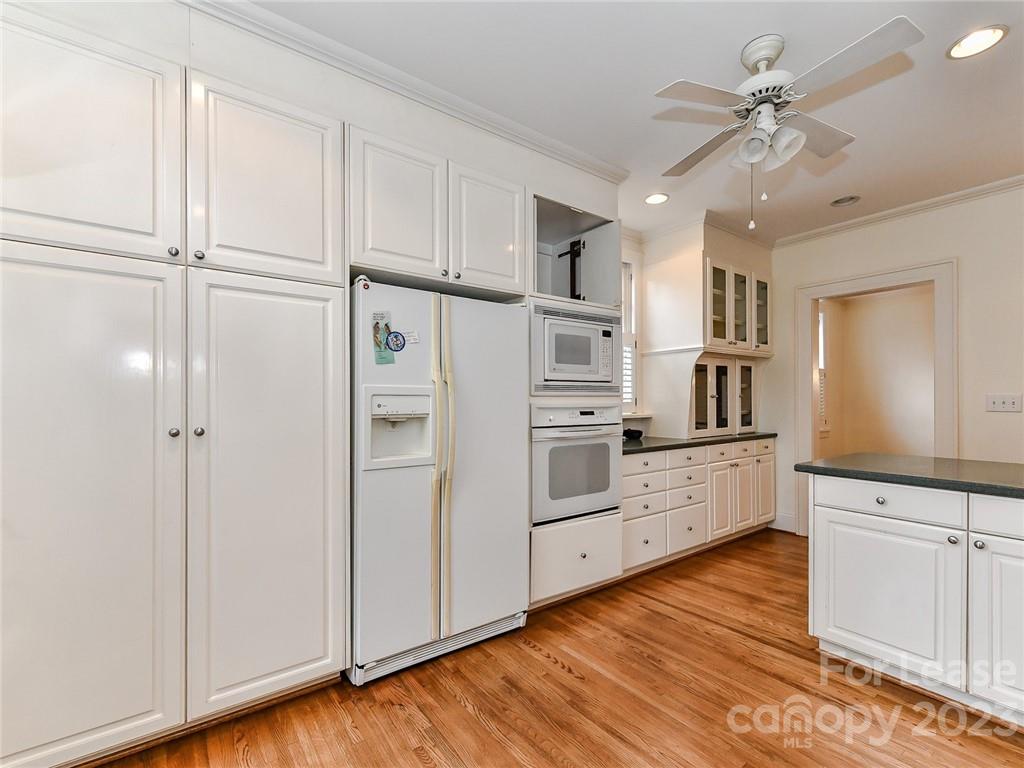 1923 Ewing Avenue Charlotte, NC 28203 - Photo 13 of 39 a kitchen with white cabinets and white appliances