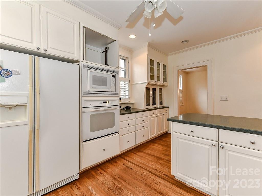 1923 Ewing Avenue Charlotte, NC 28203 - Photo 15 of 39 a kitchen with white cabinets and white appliances