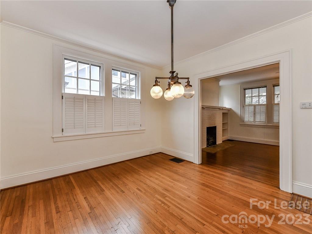 1923 Ewing Avenue Charlotte, NC 28203 - Photo 16 of 39 a view of a room with wooden floor chandelier and a window