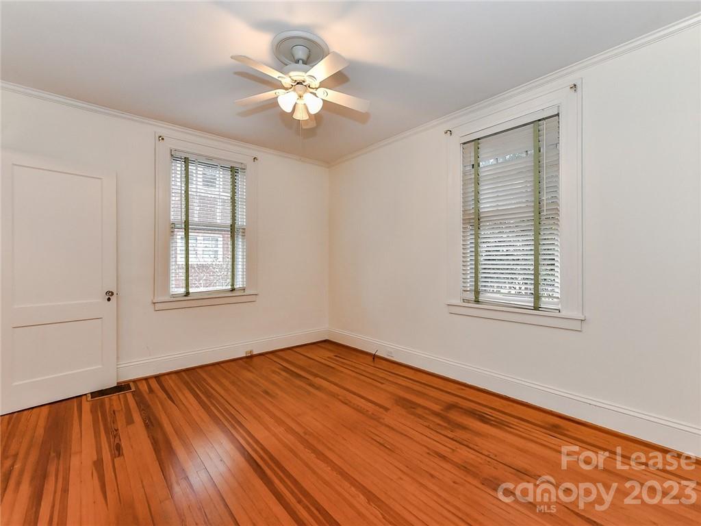 1923 Ewing Avenue Charlotte, NC 28203 - Photo 17 of 39 a view of an empty room with wooden floor and a window