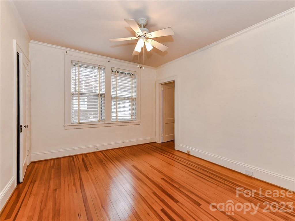 1923 Ewing Avenue Charlotte, NC 28203 - Photo 19 of 39 a view of an empty room with wooden floor and a window