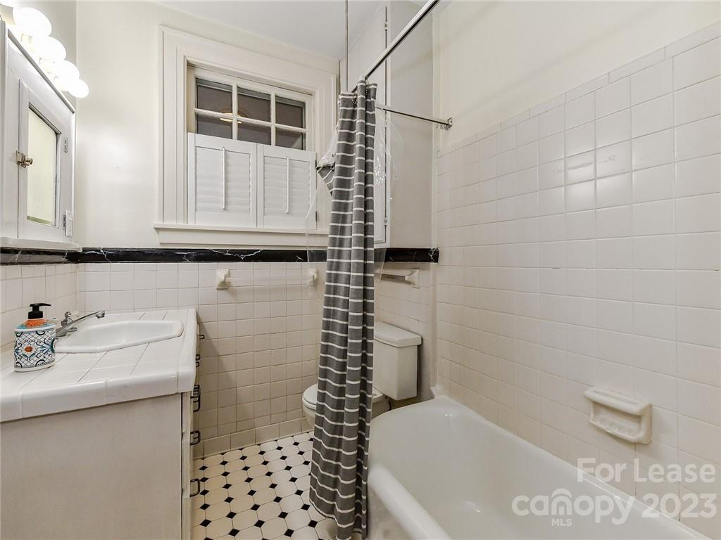 1923 Ewing Avenue Charlotte, NC 28203 - Photo 20 of 39 a bathroom with a sink a toilet and shower