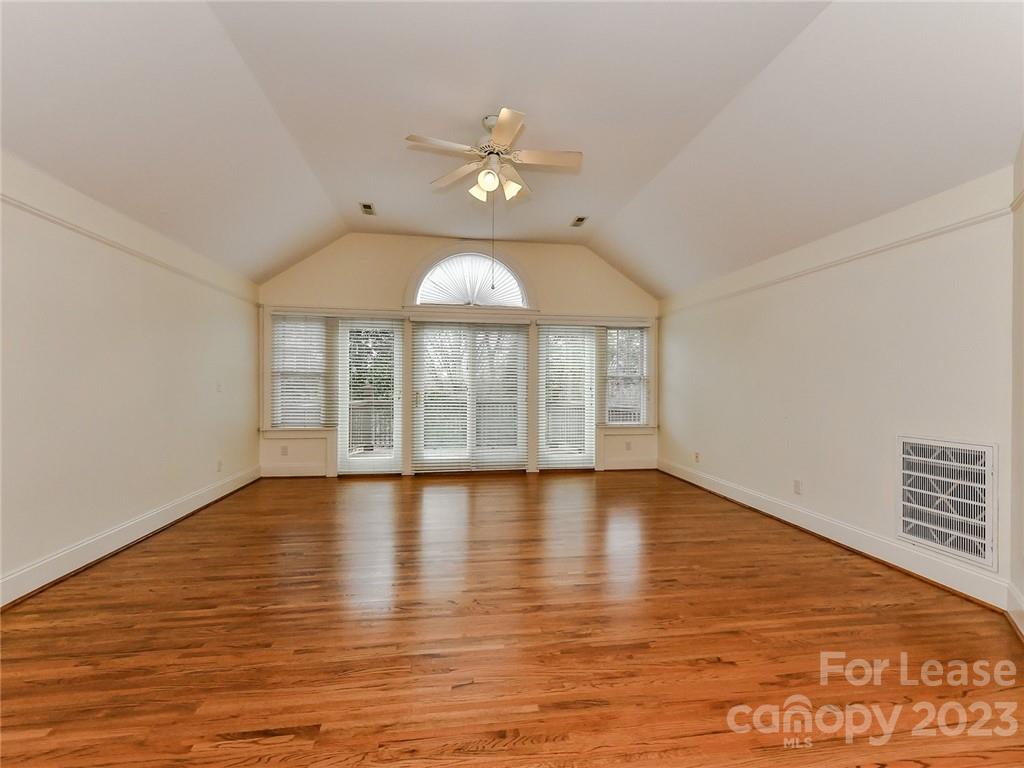 1923 Ewing Avenue Charlotte, NC 28203 - Photo 22 of 39 wooden floor in an empty room with a window