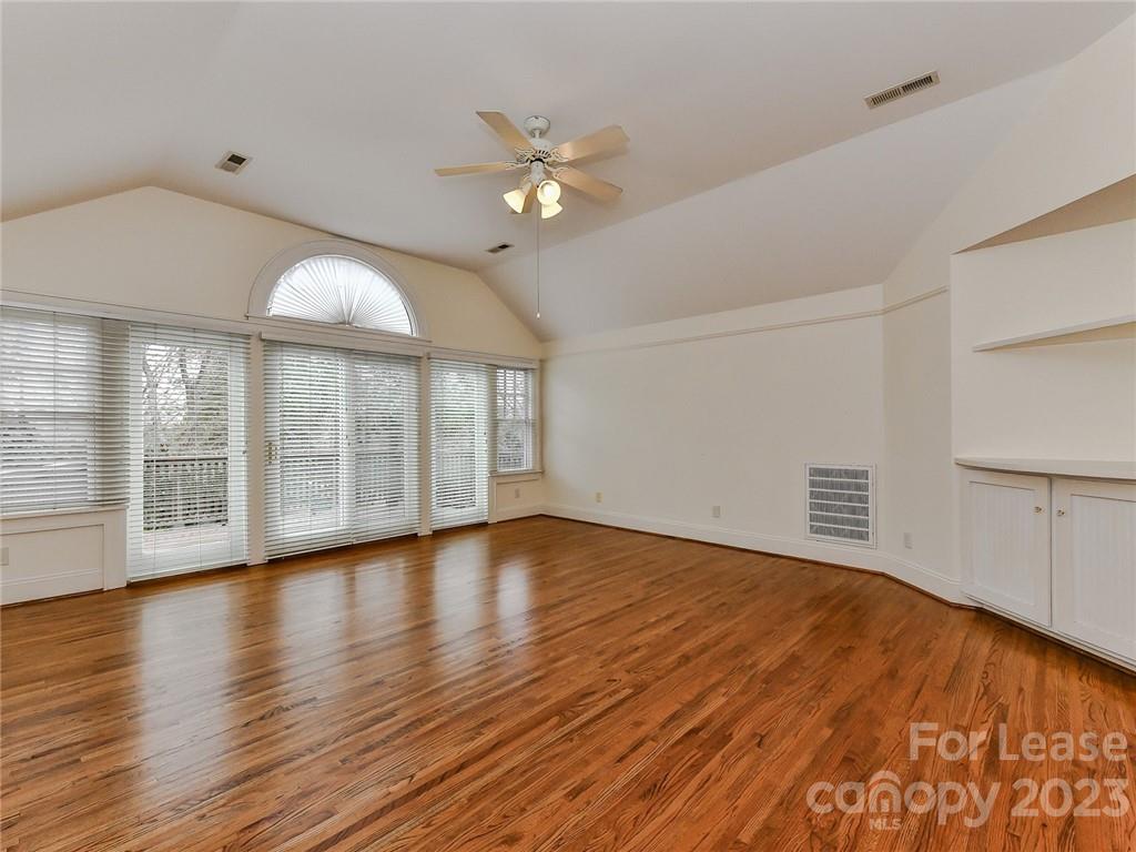 1923 Ewing Avenue Charlotte, NC 28203 - Photo 23 of 39 a view of an empty room with wooden floor and a window