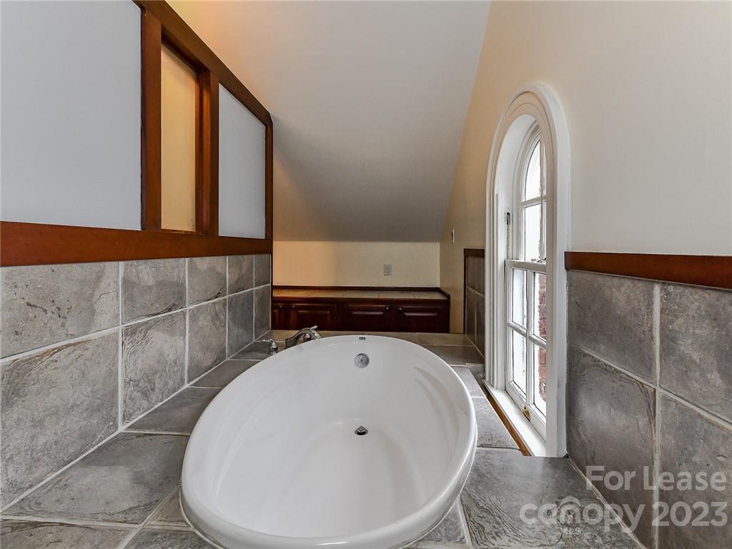 1923 Ewing Avenue Charlotte, NC 28203 - Photo 29 of 39 a bathroom with a sink and mirror