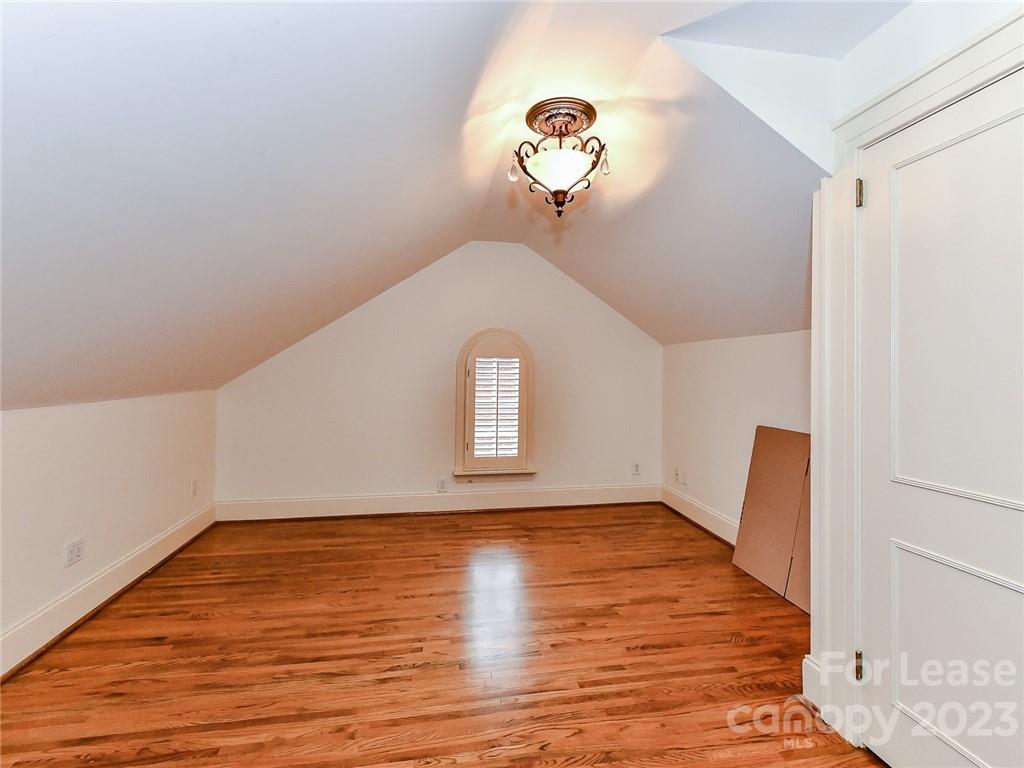 1923 Ewing Avenue Charlotte, NC 28203 - Photo 32 of 39 a view of an empty room with wooden floor and a window