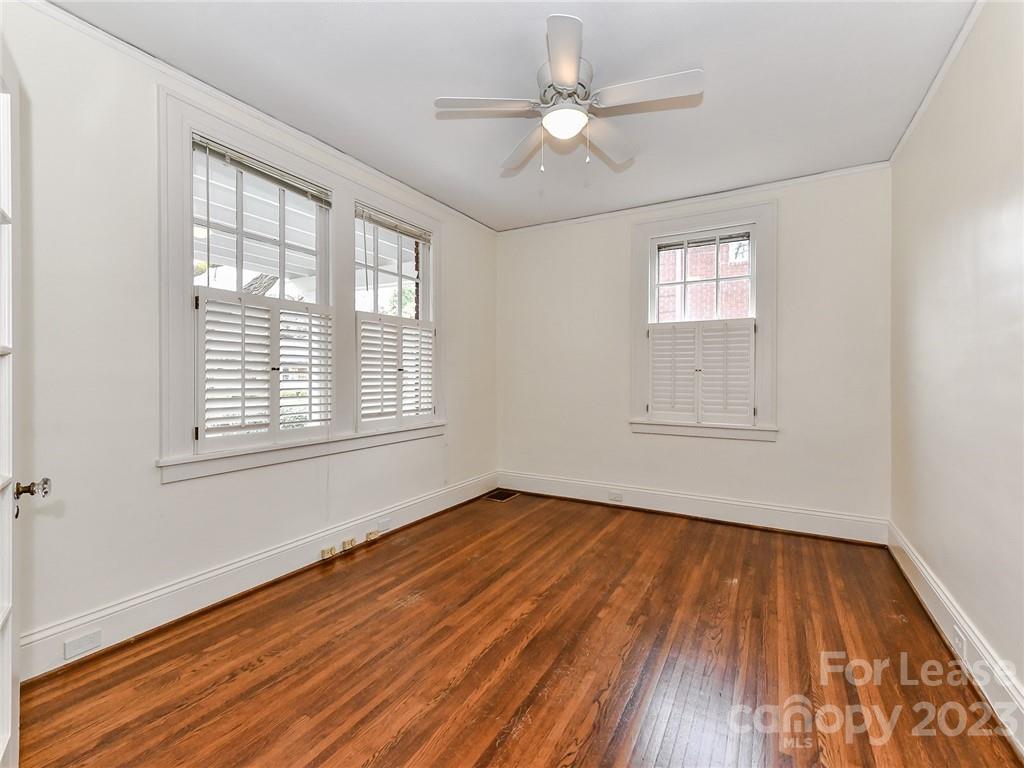1923 Ewing Avenue Charlotte, NC 28203 - Photo 6 of 39 a view of empty room with wooden floor and fan