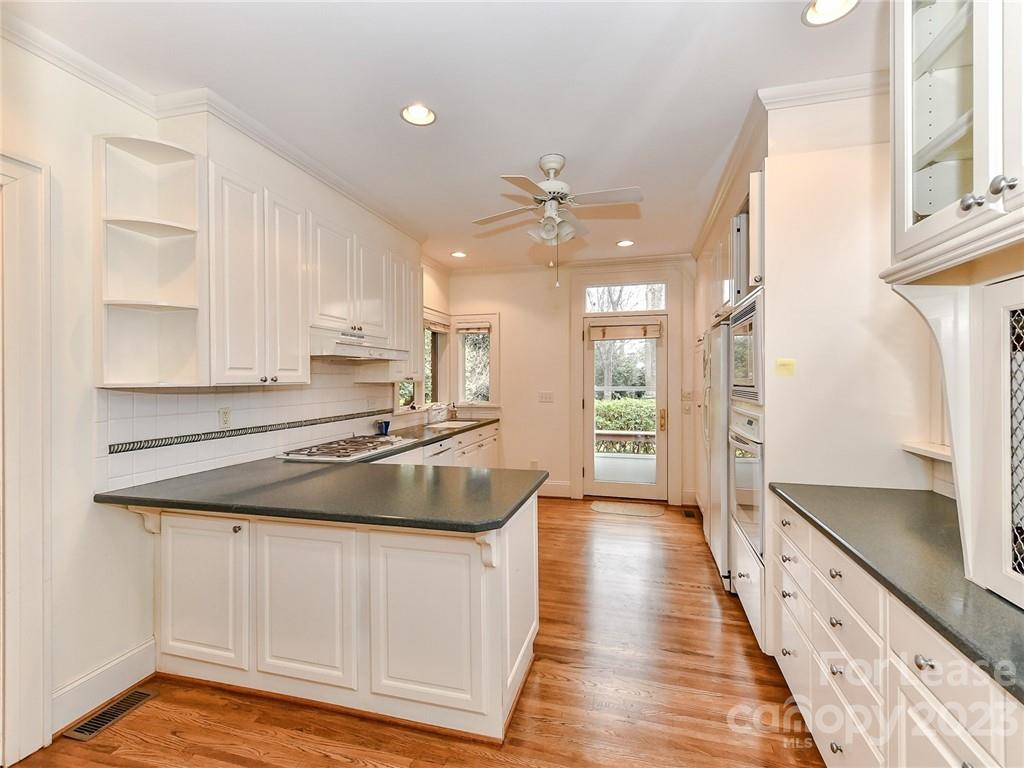 1923 Ewing Avenue Charlotte, NC 28203 - Photo 10 of 39 a kitchen with stainless steel appliances granite countertop a sink stove and refrigerator
