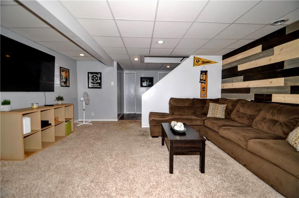 99 Thorncrest Drive McKees Rocks, PA 15136 - Photo 35 of 41 a living room with furniture and a flat screen tv