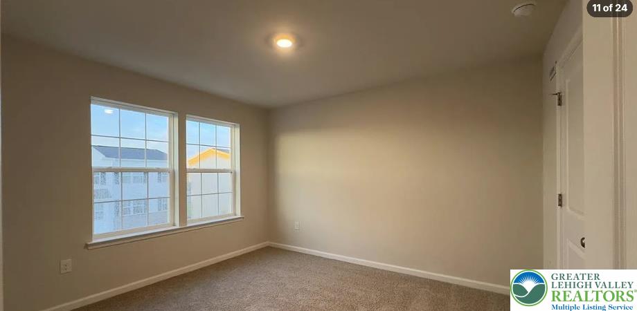 8342 Alexander Court Breinigsville, PA 18031 - Photo 5 of 9 Natural light streams through multiple windows into a comfortable bedroom with plush neutral carpeting.