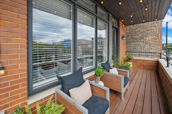 a view of balcony with two chairs and a potted plant