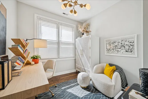 a living room with furniture and wooden floor