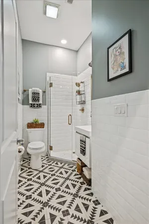 a bathroom with a sink toilet and shower