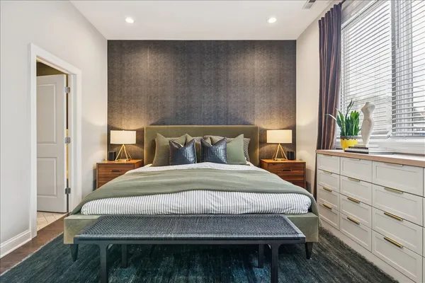 a bedroom with a bed and wooden floor