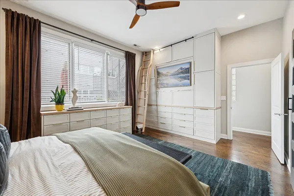 a bedroom with a bed and a large window