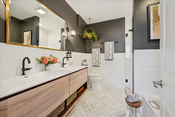 a bathroom with a sink double vanity and a mirror