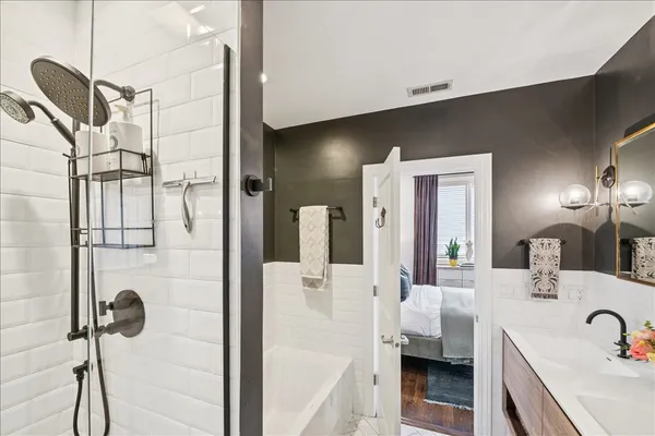 a bathroom with a tub sink and mirror