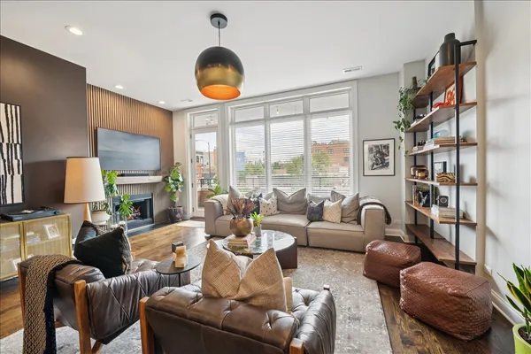 a living room with furniture a large window and a flat screen tv