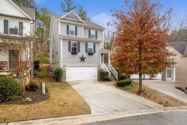 a view of a white building among the street and trees