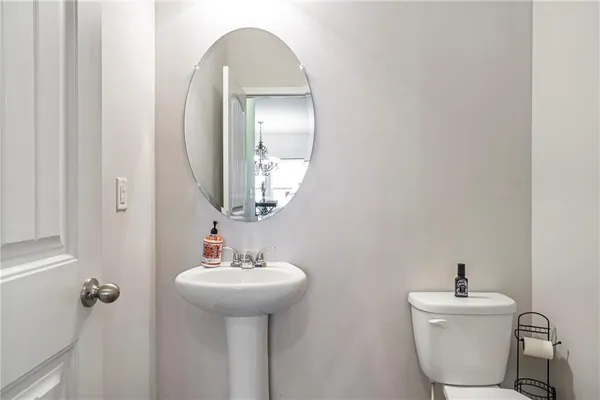 a bathroom with a sink mirror and toilet