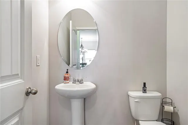 a bathroom with a sink mirror and toilet