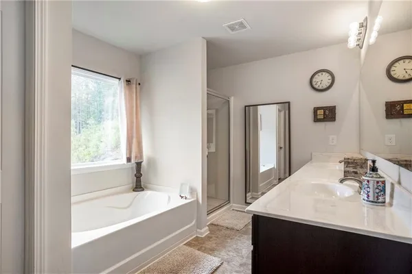 a bathroom with a bathtub and a sink