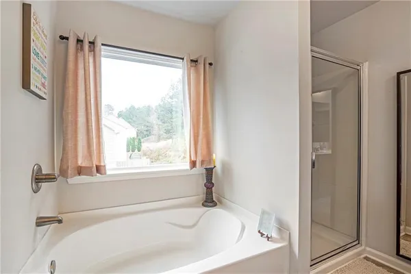 a white bath tub sitting next to a window