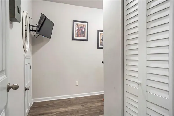 a view of a hallway with stairs and wooden floor