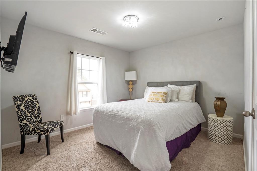 642 Royal Crest Court Canton, GA 30115 - Photo 27 of 30 a bedroom with a bed and a chair