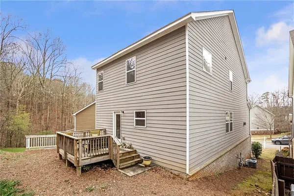 a view of a white house with a large window and wooden walls