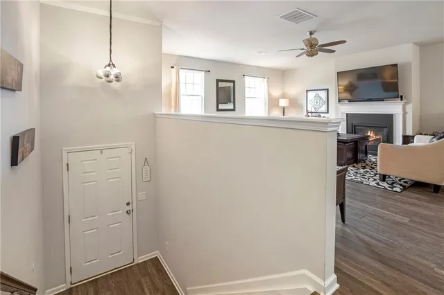 a view of a livingroom with furniture wooden floor and a ceiling fan