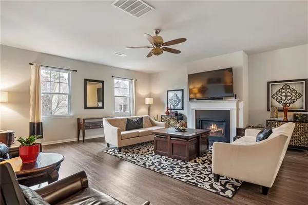 a living room with furniture fireplace and window