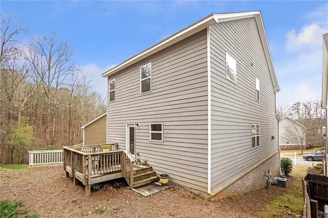 a view of a white house with a large window and wooden walls