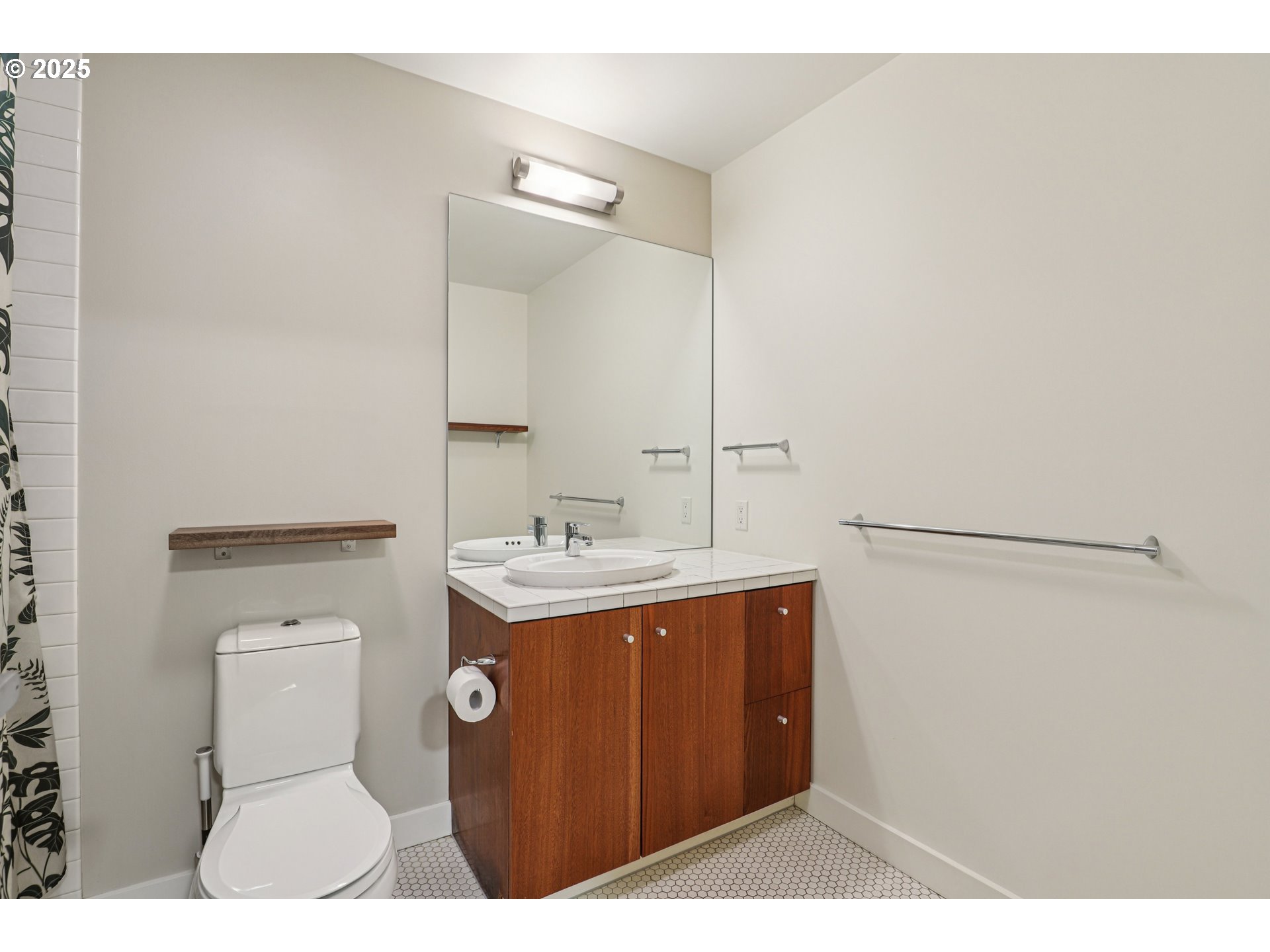 1926 West Burnside Street, Unit 906 Portland, OR 97209 - Photo 18 of 26 a bathroom with a toilet a sink and a mirror