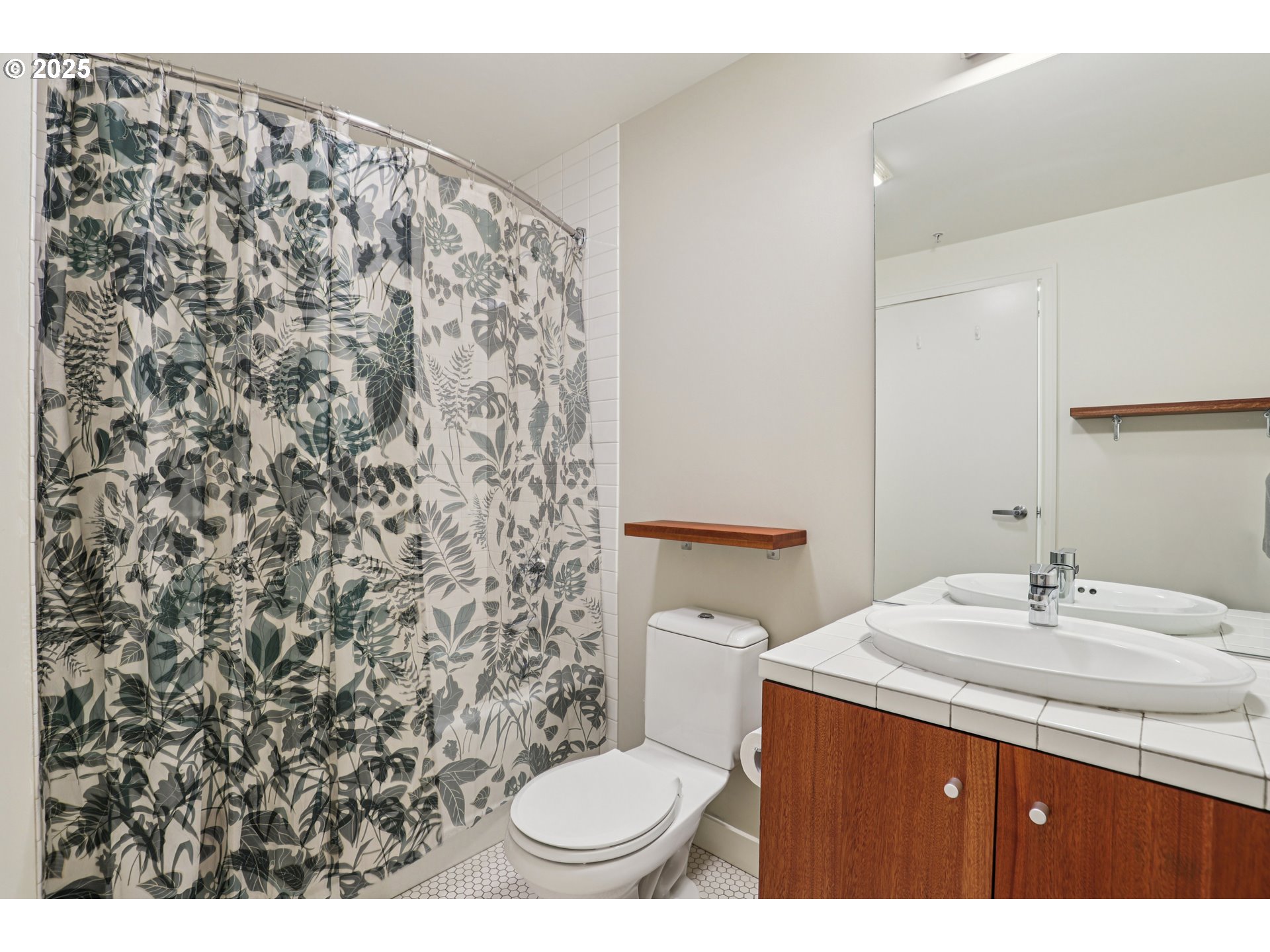 1926 West Burnside Street, Unit 906 Portland, OR 97209 - Photo 19 of 26 a bathroom with a sink toilet and mirror