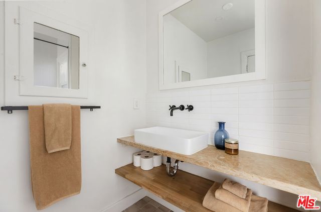 a bathroom with a sink and a mirror