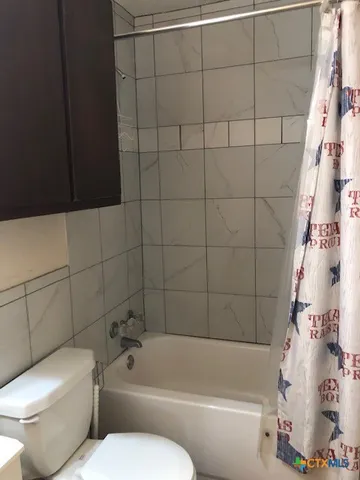 a bathroom with a toilet and bathtub